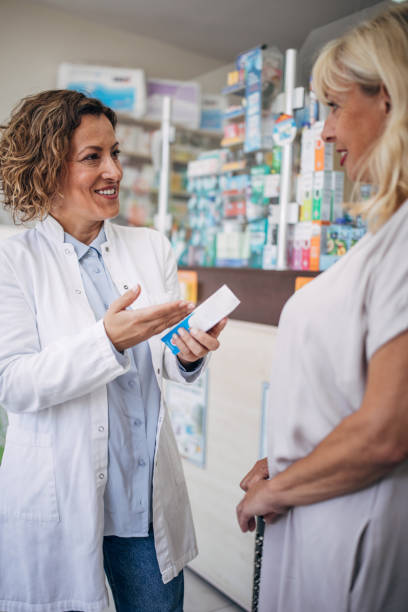 istock Pharmacist and senior customer talking in the pharmacy 2159315322