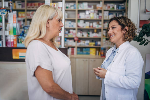 istock Pharmacist and senior customer talking in the pharmacy 2159315436