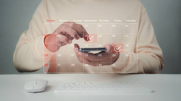 istock Businessman marking dates on virtual calendar, managing his business schedule, setting reminders for important appointments, creative collage for planning ideas, appointment scheduler. 2159316179