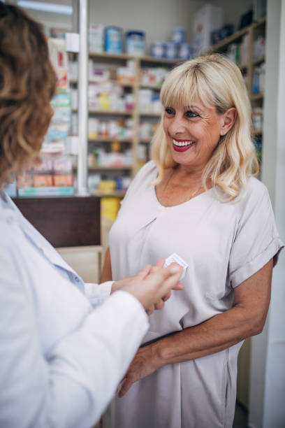 istock Pharmacist and senior customer talking in the pharmacy 2159316588