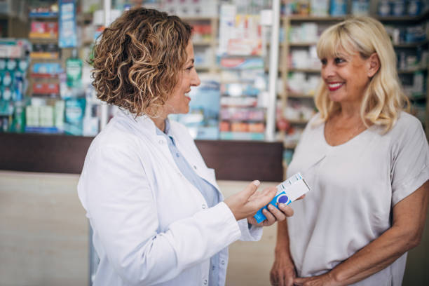 istock Pharmacist and senior customer talking in the pharmacy 2159316594