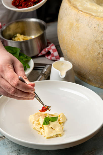 istock Fresh pasta with sauce in a whole parmesan wheel 2159317898