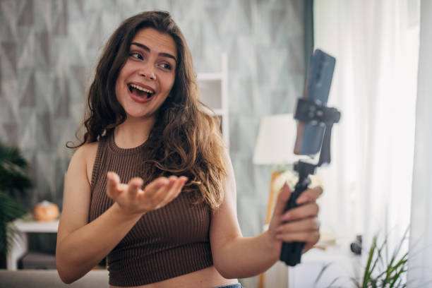 istock Amused woman vlogging with a smartphone 2159318531