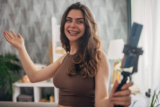 istock Enthusiastic woman with selfie stick 2159318744