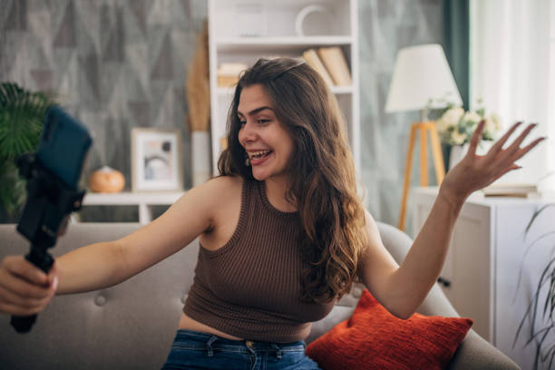 istock Young woman vlogging with phone and gimbal 2159318958