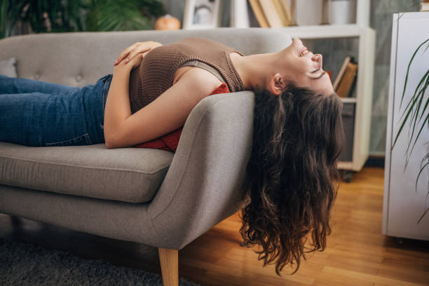 istock Woman reclining on sofa 2159320272