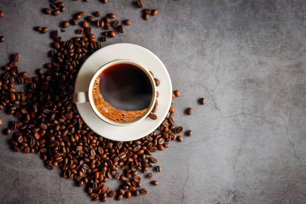 istock Overhead view of black coffee cup aromatic . Coffee cup and coffee beans on  gray background 2159320712