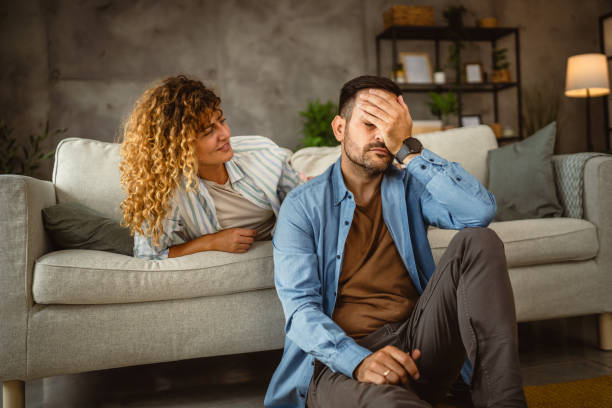 istock cheerful wife give console and support her sad depressed husband at home 2159321964