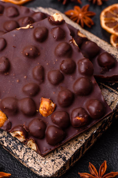 istock Black bitter chocolate with whole hazelnuts, candied fruits and mint 2159322046