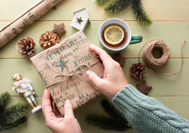 istock Women's hands hold a New Year's gift, top view 2159323187