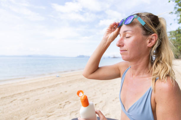 istock Woman Adjusting Sunglasses on Forehead at Beach 2159323993