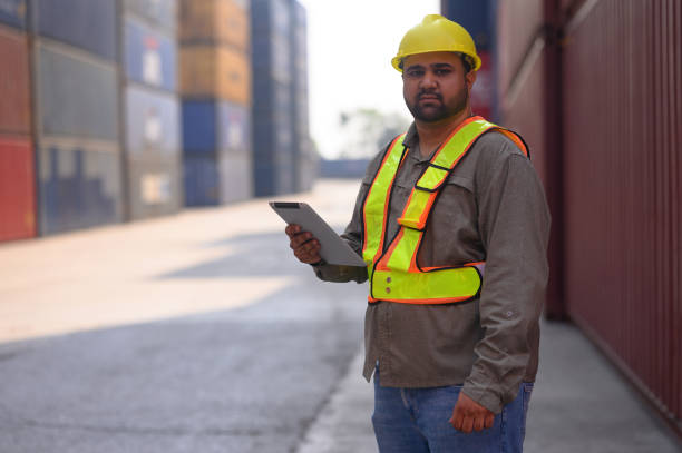 istock Manager survey load container for shipping plan in Logistic container area company. 2159324256