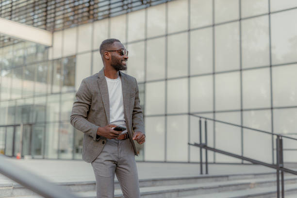 istock Businessman using phone outside the office 2159324384