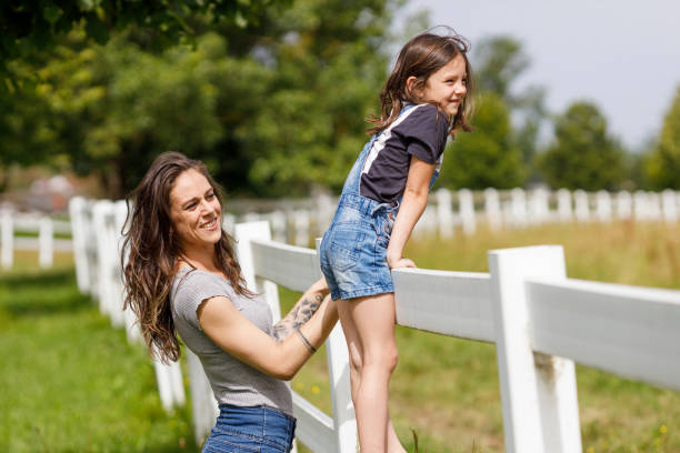 istock Mother and daughter looking at horses 2159324395