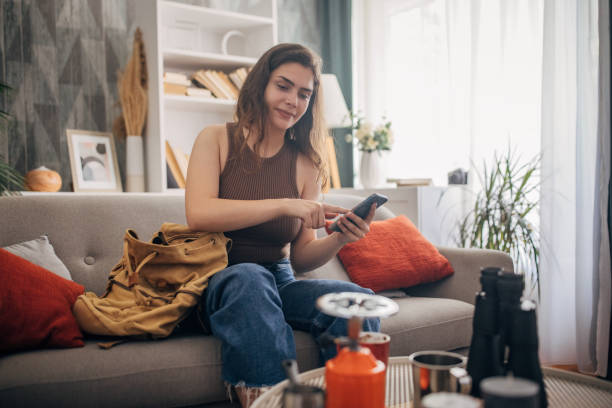 istock Young white woman preparing for a camping trip at home 2159326636