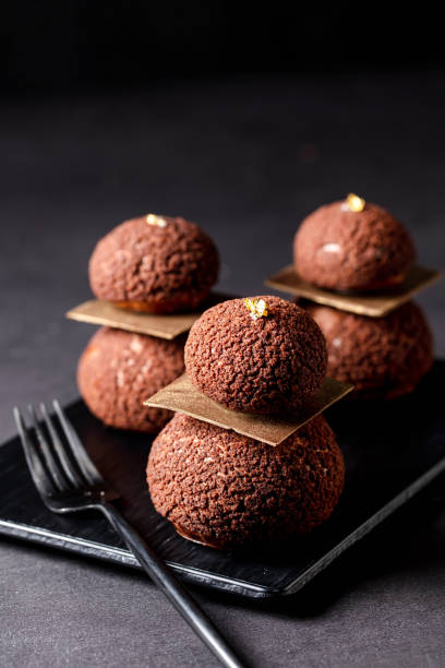 istock cacao Chocolate Puff balls with fork served in dish isolated on dark background side view of baked cafe food 2159328247