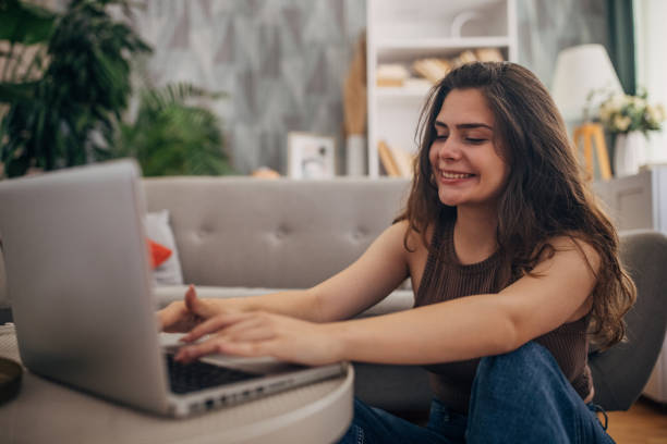 istock Smiling female typing on a laptop 2159328516