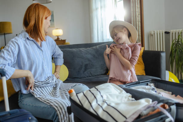 istock Mother and daughter packing for a trip at home 2159328731