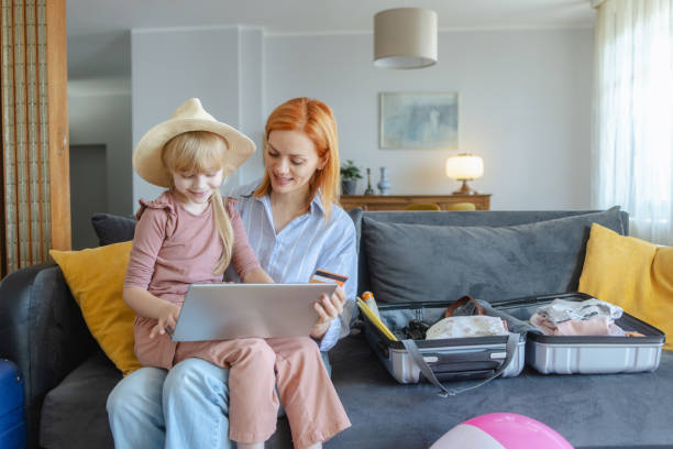 istock Happy mother and daughter making online reservation for a vacation 2159328736