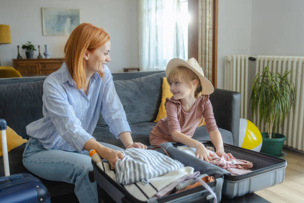 istock Mother and daughter packing for a trip at home 2159328824