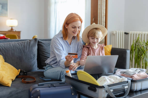 istock Happy mother and daughter making online reservation for a vacation 2159329072