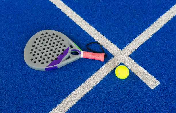 istock professional paddle tennis racket with natural lighting on blue background. Horizontal sport theme poster, greeting cards, headers, website and app 2159330090