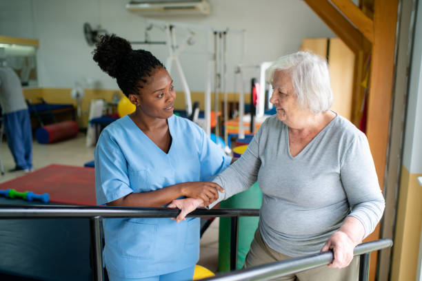 istock Therapist helping senior woman with a walking exercise on parallel bars at a rehab 2159332042