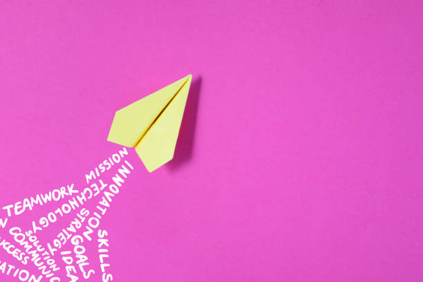 istock Paper Plane on Pink Background with Business Related Words 2159332052