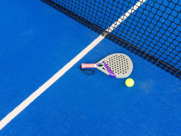 istock professional paddle tennis racket with natural lighting on blue background. Horizontal sport theme poster, greeting cards, headers, website and app 2159332162
