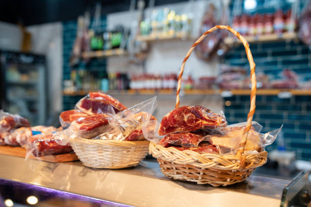 Fresh raw meat packaged in wicker baskets at grocery shop display.  Grocery shop display showcasing a variety of raw fresh meat packaged in wicker baskets.