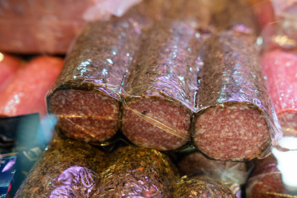 Freshly packaged meat on display in a grocery story. Fresh meat in shop refrigerator wrapped in polythene film.