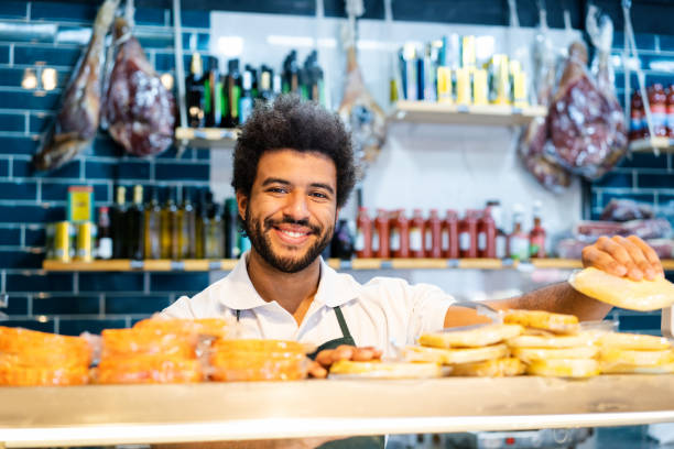 istock Salesman smiling warmly working at delicatessen shop 2159332844
