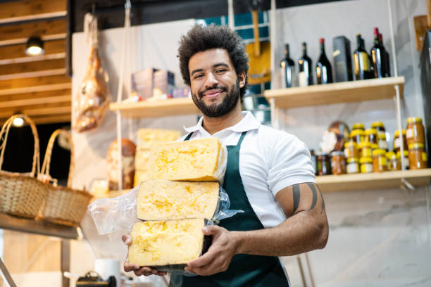 istock Cheesemonger carrying fresh cheese at grocery store 2159332856