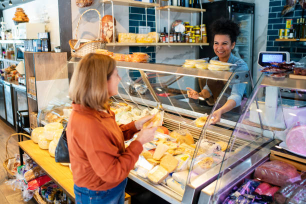 istock Senior woman purchasing cheese at a delicatessen 2159333787