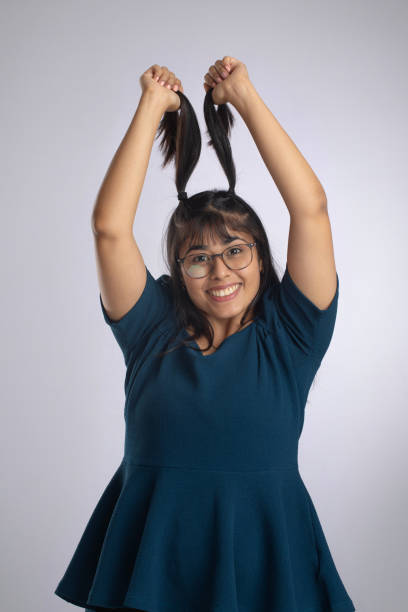 istock Happy woman holding her pigtails on white background 2159333844