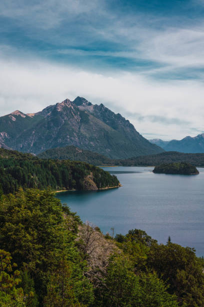 A beautiful mountain range with a lake in the foreground. The lake is calm and peaceful, and the mountains in the background create a sense of awe and wonder