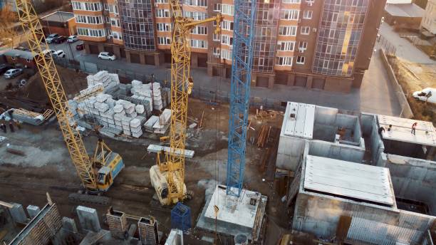 istock Cranefilled construction site with buildings in background 2159335190