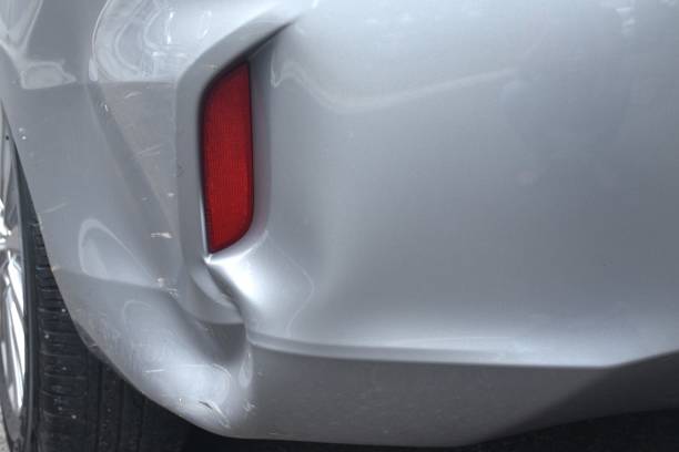 istock pound and scratch from accident on bumper of silver color car background and texture 2159336203
