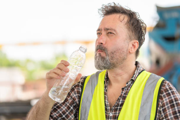 istock Man drinking water at the precast factory site, Engineer man drinking water at construction site 2159336449