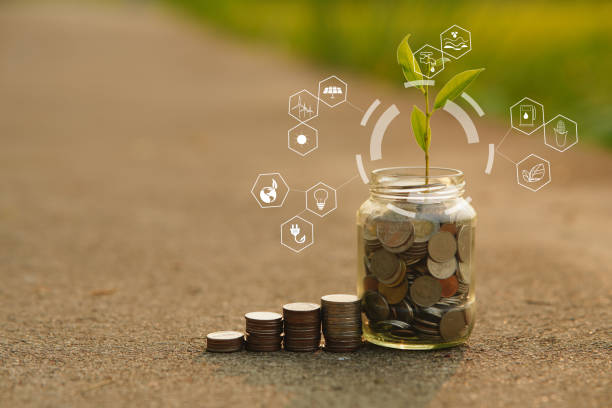 istock Saving and a coin glass on the floor nature background 2159338299