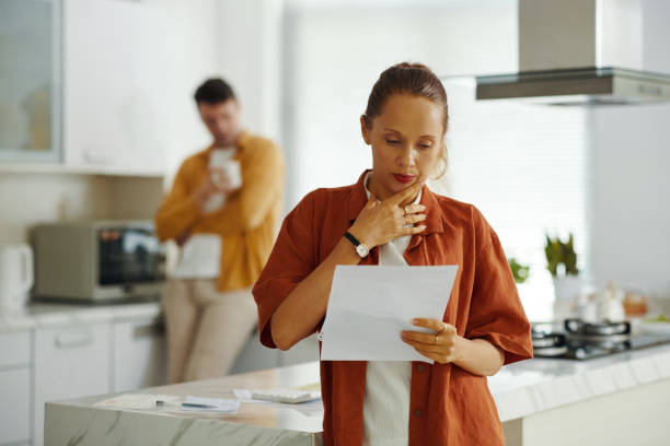 istock Woman Examining The Bill At Home 2159339237