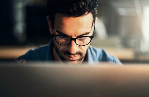 istock Business, night and man with computer, thinking and online reading for email, research for project and news reporter. Evening, editor or journalist with pc, problem solving and solution with internet 2159339692