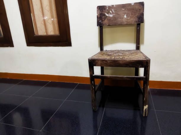 Ancient wooden windows and chairs in front of the wall