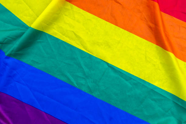 Close-up of a colorful rainbow pride flag, symbolizing LGBTQ+ pride and diversity, perfect for themes of equality, love, and inclusivity.