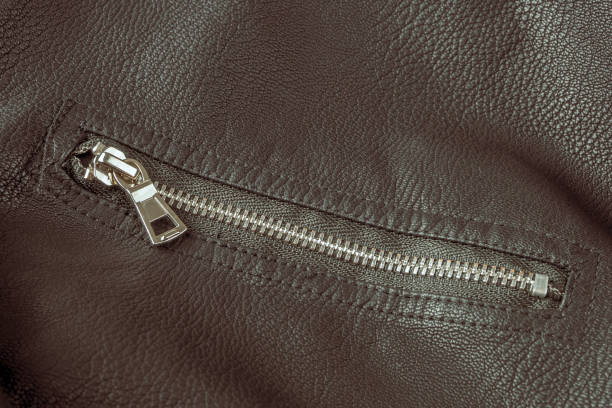 Jacket made of black leather fabric natural with modern fasteners selective focus close-up
