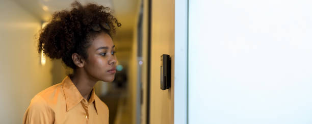 istock Woman using face scanner to unlock door in office building. Access control facial recognition system. Biometric admittance control device for security system. Biometric admittance control device 2159344681