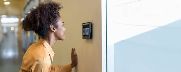 istock Woman using face scanner to unlock door in office building. Access control facial recognition system. Biometric admittance control device for security system. Biometric admittance control device 2159344683