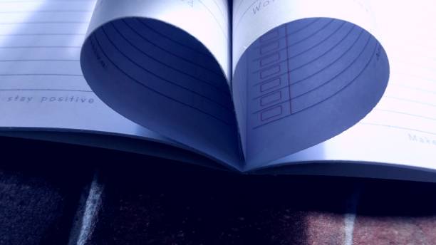istock Love-shaped sheets of white book paper. 2159346750