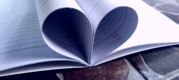 istock Love-shaped sheets of white book paper 2159347474