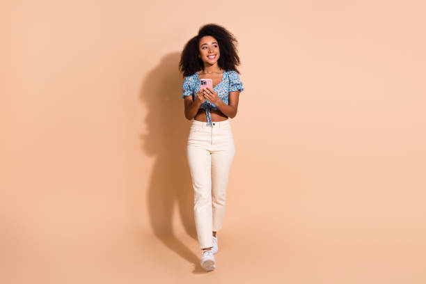 istock Photo of shiny attractive lady dressed blue blouse texting messages modern gadget empty space isolated beige color background 2159349532